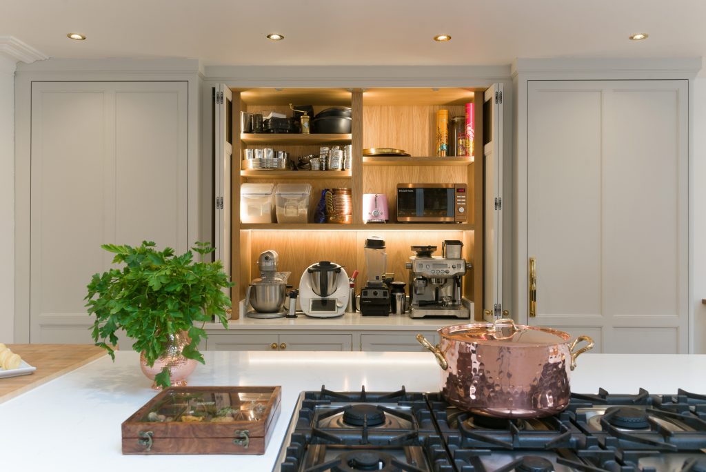 Kitchen appliance housing unit with pocket doors