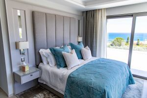 Bespoke headboard with wall lights and bedside tables