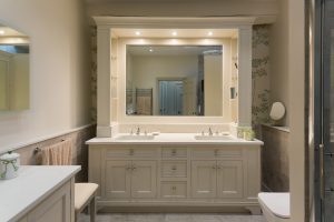 Hand painted bathroom cabinets with hidden shelving storage to side panels