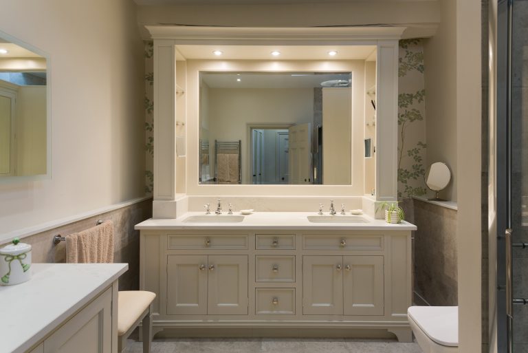 Hand painted bathroom cabinets with hidden shelving storage to side panels