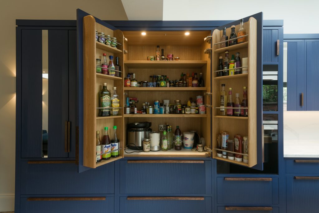 Larder with bottle racks behind doors
