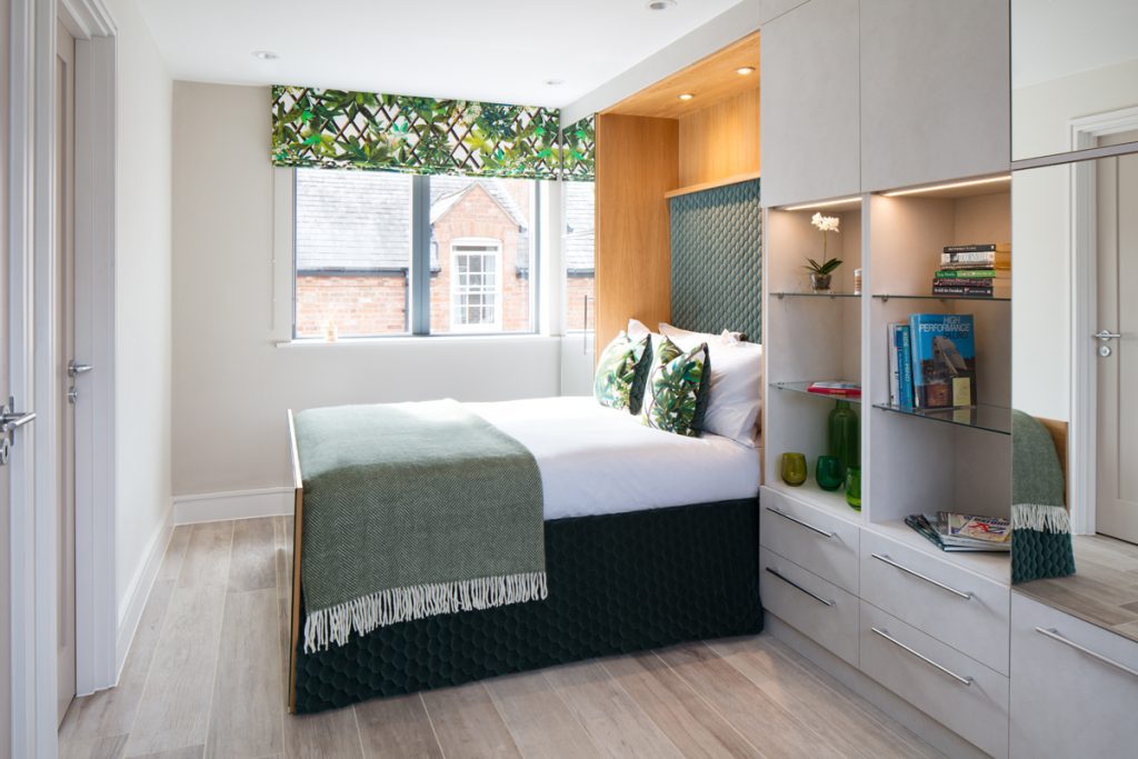 Gym turned into guest bedroom with electric drop down bed