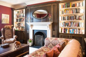 Living room with a fireplace and built-in bookshelves