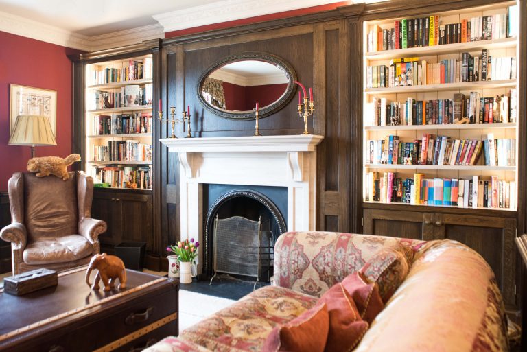 Living room with a fireplace and built-in bookshelves