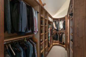 Walk-in wardrobe with hanging rails and fitted shelving