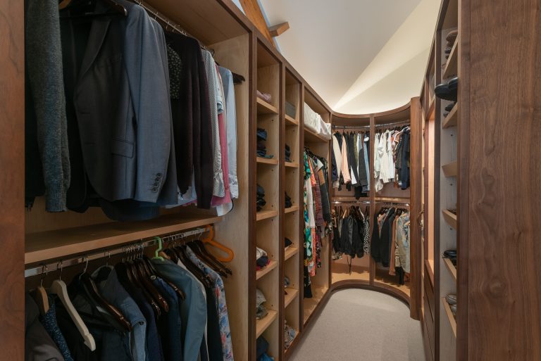 Walk-in wardrobe with hanging rails and fitted shelving