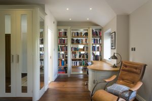 Home office with built-in bookshelves and a desk