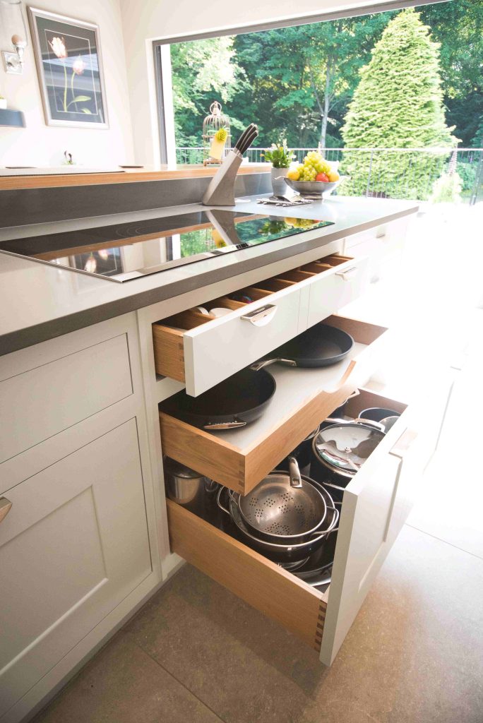 Close-up of an open kitchen drawer with fitted organiser trays