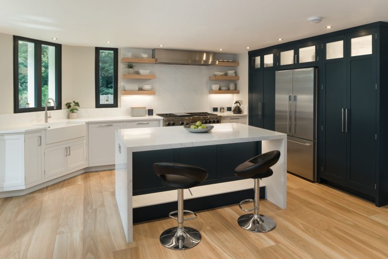 Kitchen with island, marble worktop and wood flooring