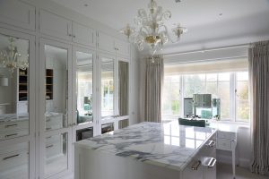 Mirrored wardrobes reflecting a bright living space