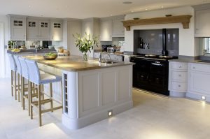 Kitchen with dark cabinetry island and brass hardware