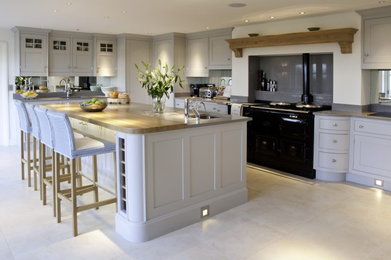 Kitchen with dark cabinetry island and brass hardware